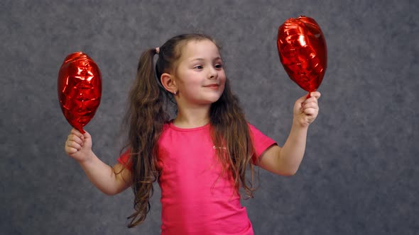 Cute girl portrait with balloons. Portrait of cute little girl holding balloons in form of heart