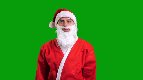 Santa Claus in Red Costume Standing and Smiling on Green Chroma Key Background