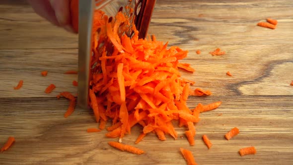 Cook Rubs Carrots on a Grater
