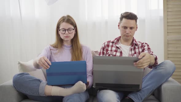 Overworked Caucasian Man and Woman Closing Laptops and Giving High Five. Satisfied Male and Female