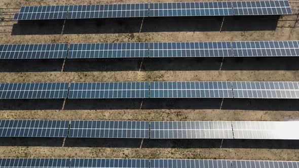 Close up of the solar panels in the desert, aerial view