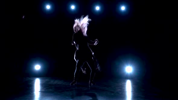 Young Couple Dancing Contemp Against Black Background with Spotlights at Studio, Slow Motion.