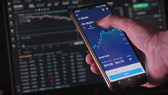 Investor Checking Bitcoin Chart on Smartphone Screen