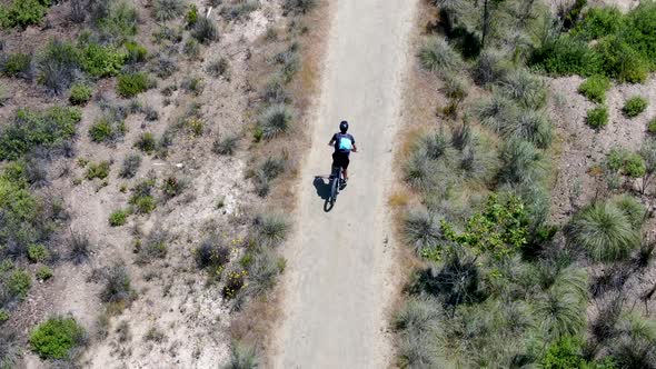 Aerial View of Riding Mountain Bike in a Small Singletrack Trail in the Mountain