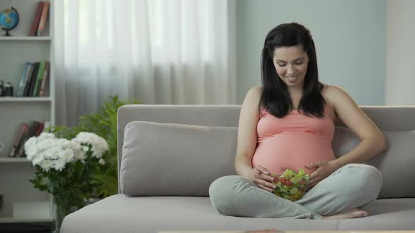 Quick With Child Woman Eating Salad Accustoming Future Child to Healthy Eating