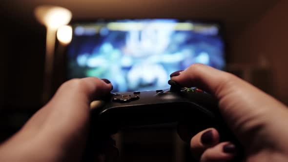 Hands Holding Gamestick Person Playing Video Games at an eSports Gaming Tournament