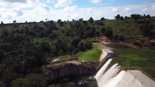 Amazing drone aerial flying over a hydroelectric power dam in a rural area on a sunny day