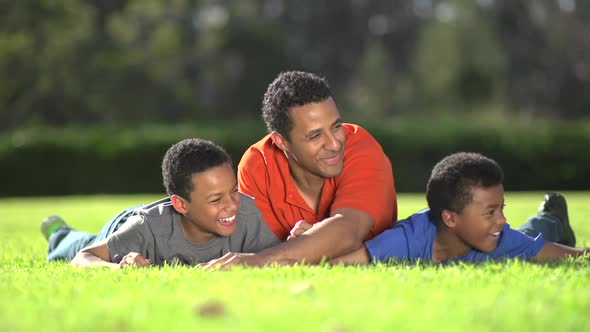 Group portrait of a father and his sons with a football