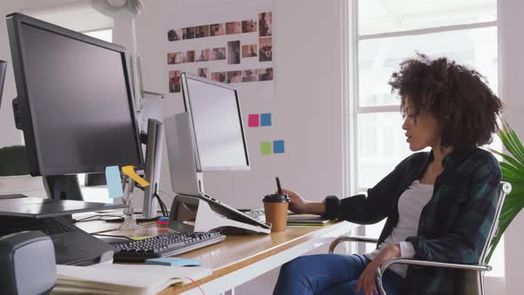 Mixed race woman working in creative office