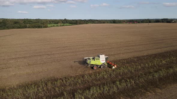 Drone shot of a combine harvester at work on a sunny day in Ireland.