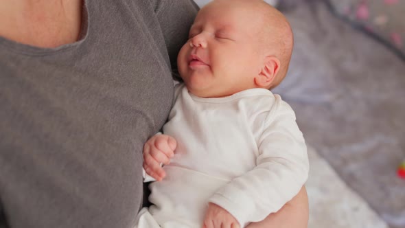 a Newborn Baby Cries in His Mother's Arms