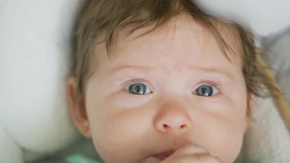 Slow Motion of Baby with Beautiful Eyes Looking Towards Camera