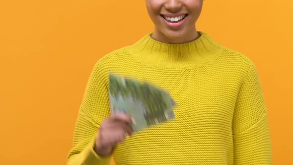 Smiling Young Female Holding Euro Banknotes and Credit Card in Hands, Payment