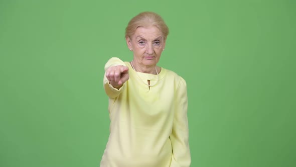 Senior Businesswoman Pointing at Camera