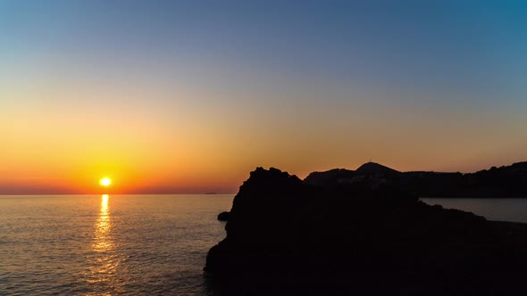 Timelapse Sunset on Beautiful Island with Silhouette Cliffs