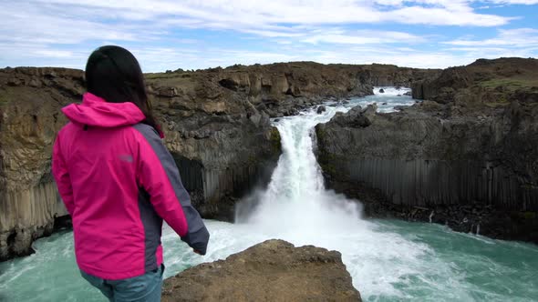 Traveler Hiking at Aldeyjarfoss Waterfall in Iceland