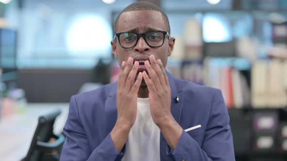 Portrait of Disappointed African Businessman Reacting Loss