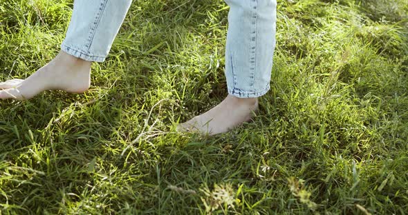 A Close Up of Bare Girl s Feet Walking on Green Summer Grass