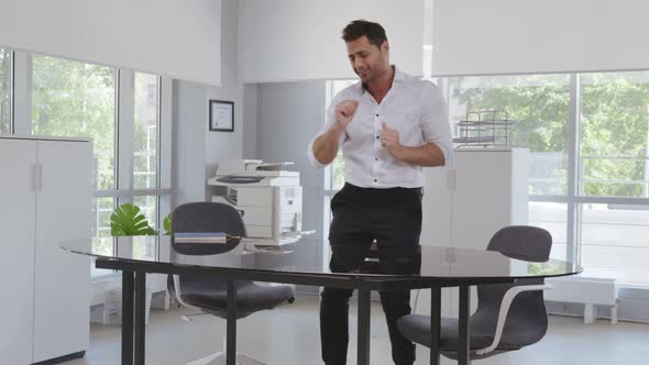 Indian Young Businessman Having Fun Taking Break in Office at Work