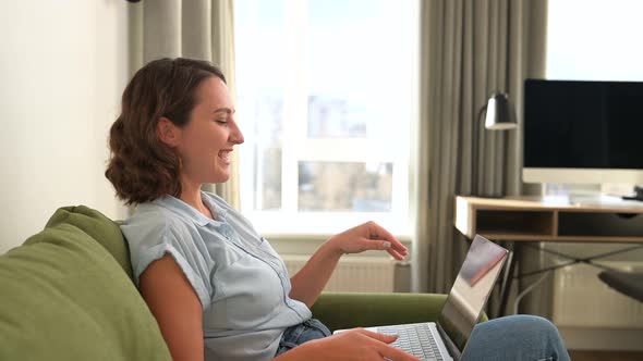 Smiling and Cheerful Young Woman Using a Laptop for Video Call Video Conference