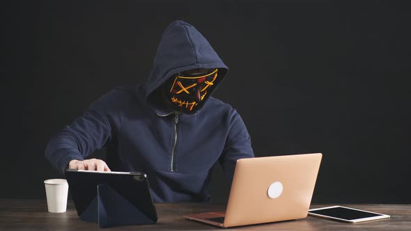Serious Hacker Man Holding Card in Hand