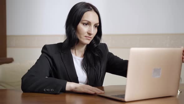Confident Positive Caucasian Woman Opening Laptop and Talking Smiling