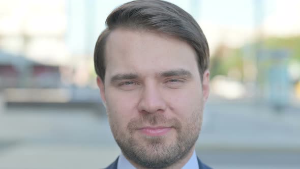 Close Up of Businessman Looking at the Camera Outdoor