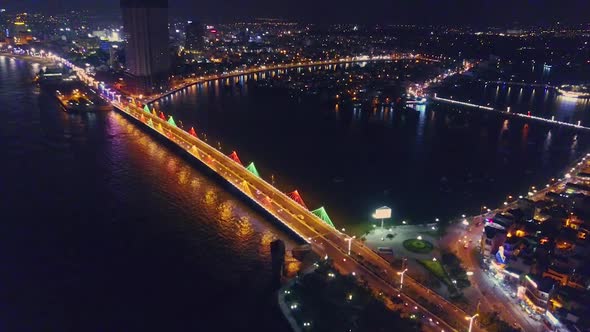 Flycam Opens View of Night City with Bridge Across Bay