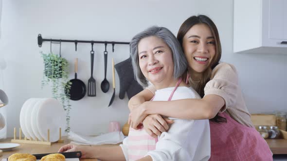 Portrait of Asian lovely family, young daughter stand with old mother.