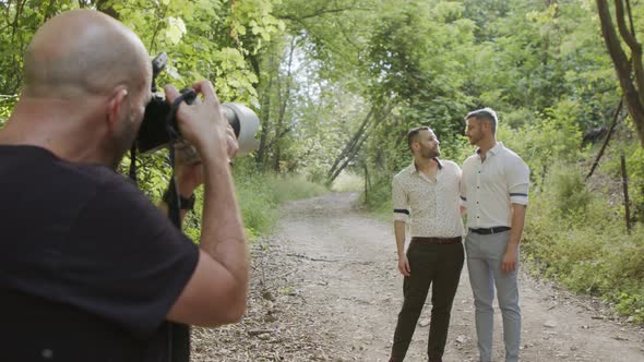 Photographer taking pictures of gay couple before their wedding