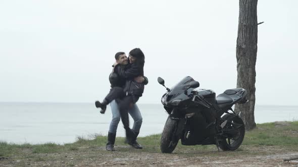 Wide Shot of Happy Young Boyfriend Spinning As Holding Girlfriend on Hands. Middle Eastern Man and