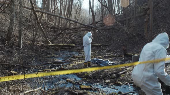 Forensic specialists working in the forest. Crime scene and police concept.