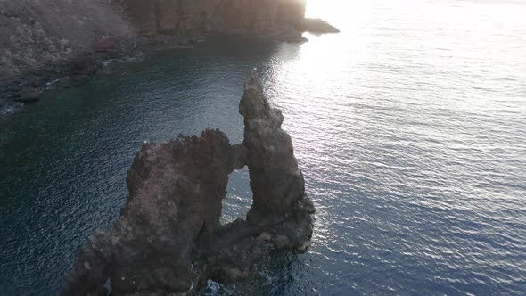 Aerial arc shot around famous rock formation El Roque de La Bonanza