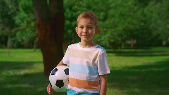 Little Kid with Ball Smiling on Nature