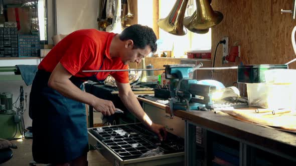 Craftsman measuring metal pieces