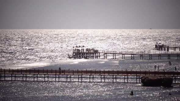 People Are Standing on the Dock Near an Open Ocean