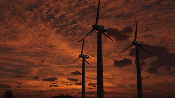 wind-powered electricity generators against a sunset sky