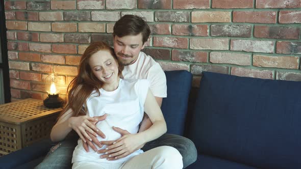 Careful Man Stroke Belly of Pregnant Wife