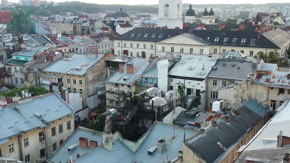 Aerial drone of a rooftop bubble restaurant in Lviv Ukraine surrounded by old European buildings dur