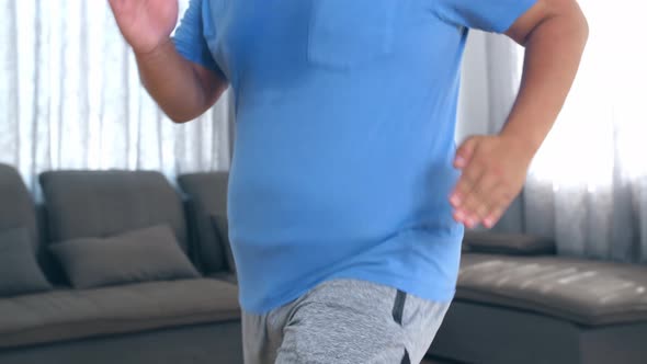Overweight Man Energetically Jogging In Place