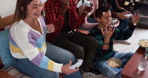 Young multiracial friends playing with video games at home - Technology and generation z people