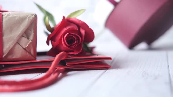 Close Up of Rose Flower and Gift Box on Table