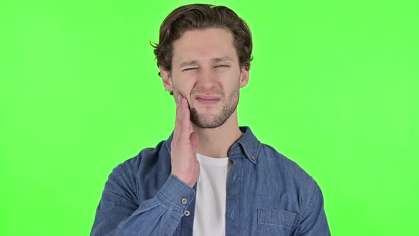 Portrait of Young Man with Toothache on Green Chroma Key