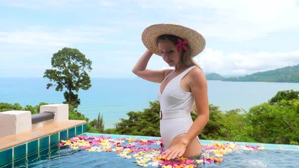 Happy Woman in Swimsuit Relaxing at Villa with Jacuzzi in Swimming Pool