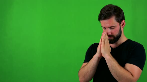 Young Handsome Bearded Man Prays - Green Screen - Studio