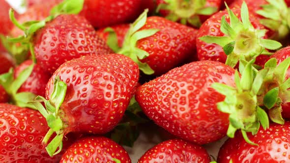 Juicy ripe exotic strawberry rotates on a white background 360. Eco fruits and berries summer.