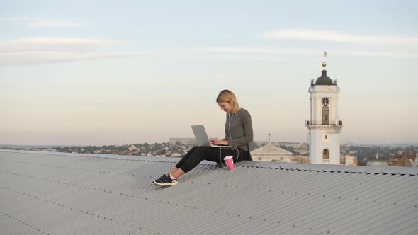 Woman with laptop on the rooftop