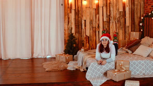 Woman Lying on Bed with Presents