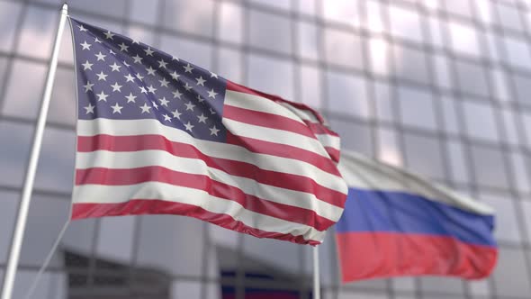 Flags of the USA and Russia in Front of a Skyscraper