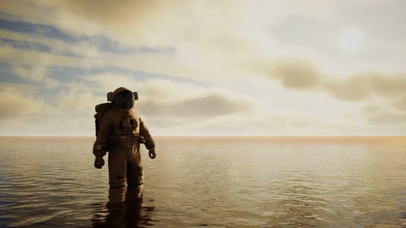 Spaceman in the Sea Under Clouds at Sunset